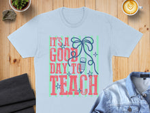 Load image into Gallery viewer, Light blue t-shirt with "It's a good day to teach" text and pencil graphic.