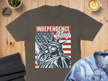 Load image into Gallery viewer, Statue of Liberty graphic with American flag and "Independence Day" text on brown t-shirt.