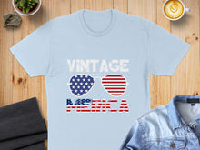 Load image into Gallery viewer, Light blue t-shirt with "VINTAGE AMERICA" and American flag sunglasses.
