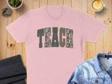 Load image into Gallery viewer, Pink t-shirt with "TEACH" in camouflage font.
