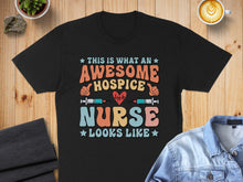 Load image into Gallery viewer, Black t-shirt with text "This is what an awesome hospice nurse looks like."