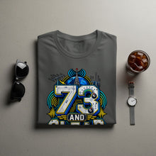 Load image into Gallery viewer, T-shirt with "73 AND" graphic featuring radio towers and a globe.