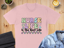 Load image into Gallery viewer, Pink t-shirt with "NURSE LIFE IS THE BEST LIFE" text and playful graphics.