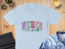 Load image into Gallery viewer, Light blue t-shirt with "Nurse Life" text and medical icons.
