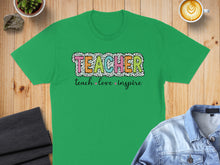 Load image into Gallery viewer, Green t-shirt with "TEACHER" in colorful letters and "teach love inspire" below.