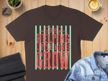 Load image into Gallery viewer, Brown t-shirt with "Helping Little Minds Grow" text and striped background.