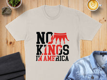 Load image into Gallery viewer, Beige t-shirt with "NO KINGS IN AMERICA" text and crown graphic.