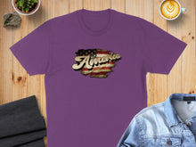 Load image into Gallery viewer, Purple t-shirt with distressed "America" text overlaying an American flag graphic.
