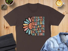 Load image into Gallery viewer, Brown t-shirt with colorful floral design and text "I became a hospice nurse because your life is worth my time".
