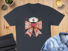 Load image into Gallery viewer, Dark grey t-shirt featuring a pink bow with a nurse's cap, stethoscope, and "XOXO" text.
