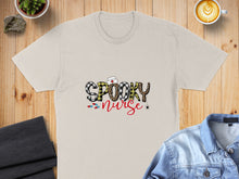 Load image into Gallery viewer, "Spooky Nurse" text with Halloween accents on a cream t-shirt.