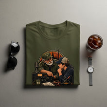 Load image into Gallery viewer, Olive green t-shirt with graphic of two people and ham radio equipment.