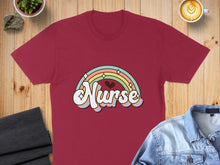 Load image into Gallery viewer, Maroon t-shirt with a retro rainbow and "Nurse" text graphic.