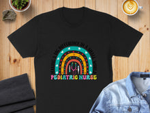 Load image into Gallery viewer, Black t-shirt with colorful rainbow and stethoscope design: "MAKING A BIG DIFFERENCE IN A SMALL WORLD PEDIATRIC NURSE".