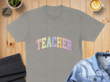Load image into Gallery viewer, Grey t-shirt with "TEACHER" in pastel letters, laid flat.