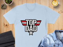 Load image into Gallery viewer, Light blue t-shirt with distressed "TOP DAD" logo in red, white, and blue.