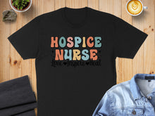 Load image into Gallery viewer, Black t-shirt with "Hospice Nurse Love Inspire Heal" text in colorful retro font.