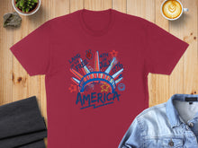 Load image into Gallery viewer, Maroon t-shirt with "LAND OF THE FREE 4TH OF JULY 1776 AMERICA" graphic.
