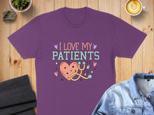 Load image into Gallery viewer, Purple t-shirt with "I Love My Patients" and heart graphic.