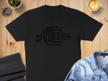 Load image into Gallery viewer, Black t-shirt with "America Est. 1776" text and distressed American flag graphic.