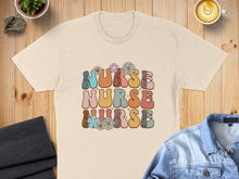 Load image into Gallery viewer, "Nurse" text in retro floral and leopard print font on a t-shirt.