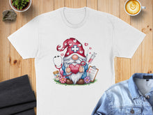 Load image into Gallery viewer, White t-shirt with a gnome graphic holding a heart and stethoscope.