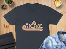 Load image into Gallery viewer, Dark t-shirt with retro "Nurse" text in pastel colors and floral accents.