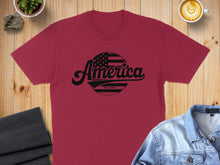 Load image into Gallery viewer, Maroon t-shirt with "America EST. 1776" in a distressed flag circle.