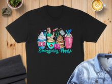Load image into Gallery viewer, Black t-shirt with "Emergency Nurse" text and coffee cup illustrations.