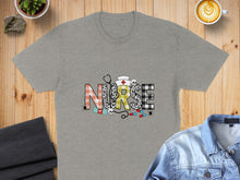 Load image into Gallery viewer, Grey t-shirt with "NURSE" in colorful, patterned letters and medical icons.