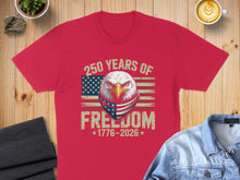 Load image into Gallery viewer, Red t-shirt with eagle, American flag mask, and "250 Years of Freedom 1776-2026".