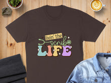 Load image into Gallery viewer, Brown t-shirt with "Livin' the Scrub Life" text and colorful stethoscope.