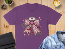 Load image into Gallery viewer, Pink graphic tee with stethoscope, caduceus, and XOXO nurse's cap.