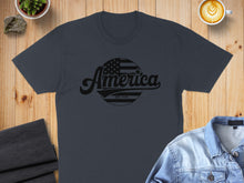 Load image into Gallery viewer, Dark gray t-shirt with "America Est. 1776" text and flag graphic.