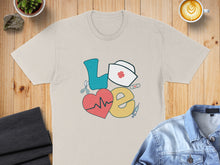Load image into Gallery viewer, Beige t-shirt with "LOVE" graphic featuring heart, stethoscope, and nurse's cap.