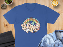 Load image into Gallery viewer, Blue t-shirt with "Nurse Life" text, rainbow, and syringe graphic.