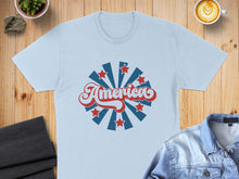 Load image into Gallery viewer, Light blue t-shirt with retro "America" text and starburst design.