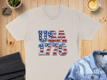 Load image into Gallery viewer, Cream t-shirt with "USA 1776" text in patriotic stars and stripes design.