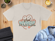 Load image into Gallery viewer, Cream t-shirt with "School Nurse" text and stethoscope, featuring a heart and heartbeats.