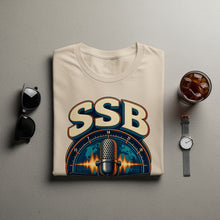 Load image into Gallery viewer, Light beige t-shirt with "SSB" text and vintage microphone graphic.