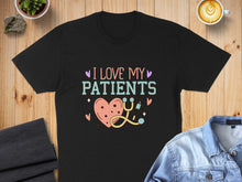 Load image into Gallery viewer, Black t-shirt with "I Love My Patients" text, heart, and stethoscope design.