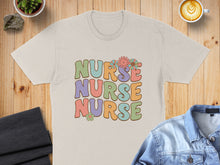 Load image into Gallery viewer, T-shirt with "NURSE NURSE NURSE" in retro floral font.