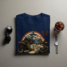 Load image into Gallery viewer, T-shirt graphic depicts a hiker using a map with a compass and radio equipment.