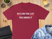 Load image into Gallery viewer, Red t-shirt with "HE'S ON THE LIST YOU KNOW IT" text in white and blue.