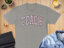 Load image into Gallery viewer, Gray t-shirt with "TEACH" spelled out in a floral pattern.