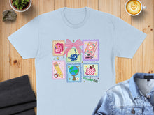 Load image into Gallery viewer, Light blue t-shirt with pastel school-themed stamps including a backpack, globe, and apple.