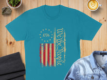 Load image into Gallery viewer, Teal t-shirt with distressed American flag and "We the People" text.