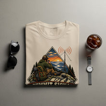 Load image into Gallery viewer, T-shirt with "Summit Signal" graphic of a man with radio equipment in the mountains.
