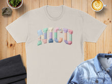 Load image into Gallery viewer, Beige t-shirt with "NICU" in pastel patchwork letters.