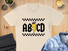 Load image into Gallery viewer, Cream t-shirt with "ABCD" text and lightning bolt graphic.